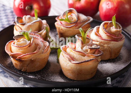 Beautiful apple cake in the form of roses. Festive pastry, horizontal closeup Stock Photo