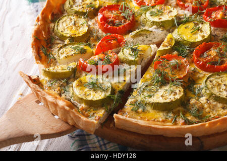 Sliced vegetable tart with cheese tomatoes and zucchini closeup. horizontal Stock Photo