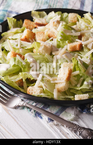 American Classic Caesar Salad close-up on a plate on the table. vertical Stock Photo