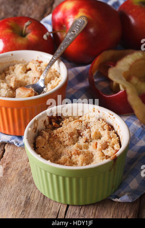 English crumble with apples close-up in the pot. vertical rustic style Stock Photo