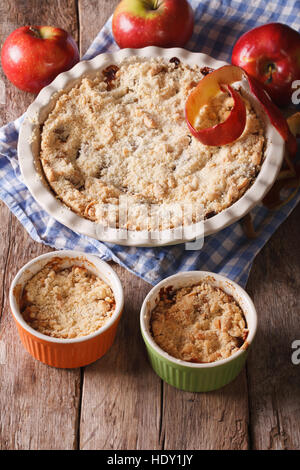 Crumble with apples close-up in baking dish. Vertical, rustic style Stock Photo