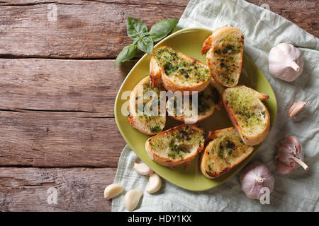 toasted bread with garlic and herbs on a plate. view from above horizontal, rustic style Stock Photo