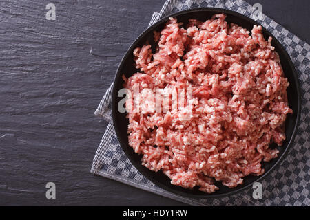 Raw minced pork in a plate on the table. horizontal view from above Stock Photo