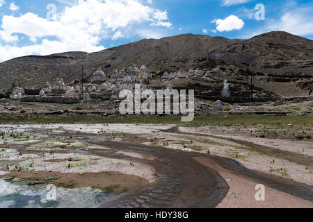 small stream flowing in front of chortens Stock Photo