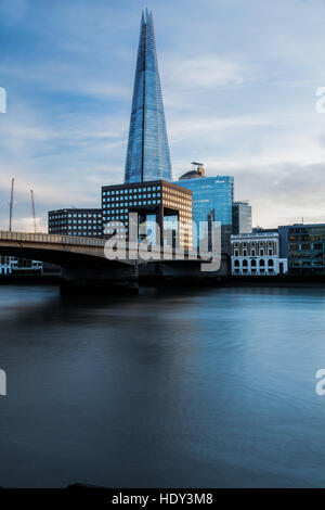 London's Shard photographed at sunset from the northside of the  river Thames and showing London Bridge Stock Photo