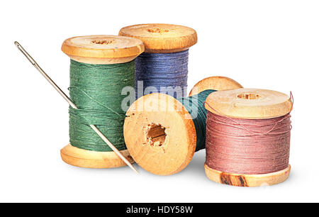 Needle and multicolored thread on wooden spool isolated on white background Stock Photo