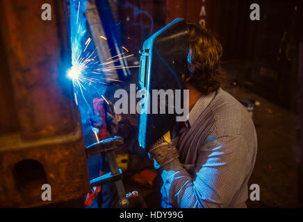 Arc welder working on a furnace unit in a German machine factory. Stock Photo