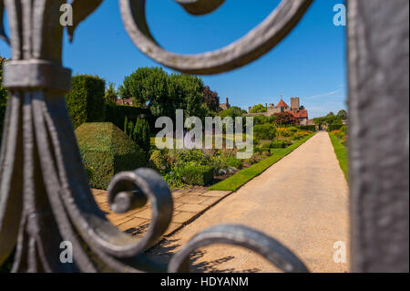 Looking at the gardens through the gates of the Entrance to Penshurst Place Penshurst Kent. Stock Photo