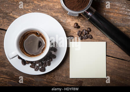 Coffee beans, ground and cup of espresso on the wooden table, flat lay, cafe concept Stock Photo