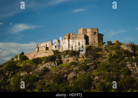 Beautiful Spanish old castle over a hill with a amazing sky of background Stock Photo