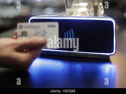 A demonstration takes place of the world's first contactless, self-serving beer pump developed by Barclaycard to help cut bar queues on nights out, at Henry's Cafe and Bar in Piccadilly, London. Stock Photo