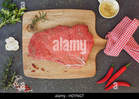Raw beef steak seasoned with salt and pepper, top view Stock Photo