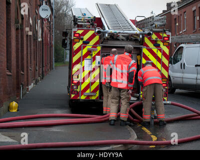 Oldham Lancashire, UK. 15th Dec, 2016. Huge fire was attended by the Greater Manchester Fire Services in Oldham Lancashire, at one stage the flames were roaring above the building. The whole surrounding area was cordoned off as the fire fighters battled with the blaze. Credit:  jozef mikietyn/Alamy Live News Stock Photo