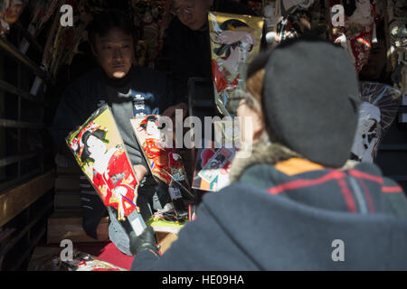 Tokyo, Tokyo, Japan. 17th Dec, 2016. Decorated battledores, shuttlecocks and kites are on sale at open-air stalls during an annual fair held on the grounds of Sensoji Buddhist Temple in Tokyos downtown Asakusa in Tokyo. The fair originated in the 16th century from a custom to give a battledore and pray for the healthy growth of girls, symbolizing the racket as a ''board to bounce back evil. © Alessandro Di Ciommo/ZUMA Wire/Alamy Live News Stock Photo