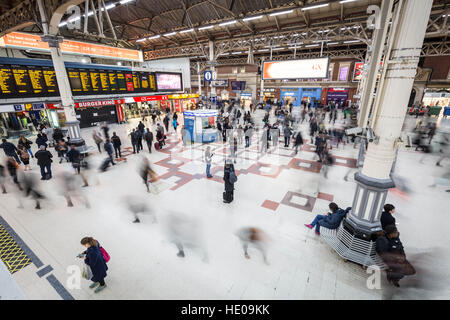 Commuters seen during rush hour at Victoria train station in London, UK. Stock Photo