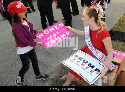 Orlando, Florida, USA. 16th Dec, 2016. Miss National Patriot hands out signs to people as they arrive to hear President-elect Donald Trump speak during a 'Thank You Tour' rally on December 16, 2016 at the Central Florida Fairgrounds in Orlando, Florida. © Paul Hennessy/Alamy Live News Stock Photo