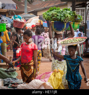 African women carrying trays and bowls Stock Photo