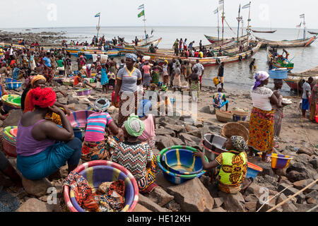 Busy traffic on beach in Tombo Harbour, Sierra Leone. Women are waiting for more fishing boats to arrive. The only white man in this picture: Christiano Ronaldo (CR7) isolated from the others printed on a T-shirt