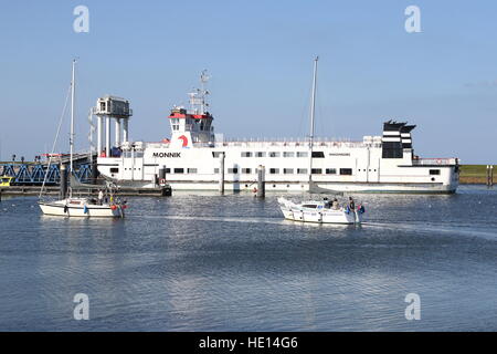 Ferry boat loading passenger to the Wadden Sea island of Schiermonnikoog,  Lauwersoog Harbour, Friesland,  Northern Netherlands Stock Photo