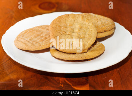 Homemade peanut butter cookies on a white plate on a wood pine table. Closeup.Oklahoma, USA. Stock Photo