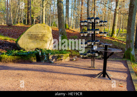 Bredakra, Sweden - December 14, 2016: Documentary of local cemetery. Small and tranquil memorial place with large granite stone with inscriptions Stock Photo