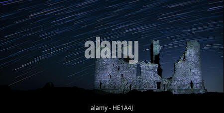 A Night Sky full of Stars at Dunstanburgh Castle in Northumberland, UK Stock Photo