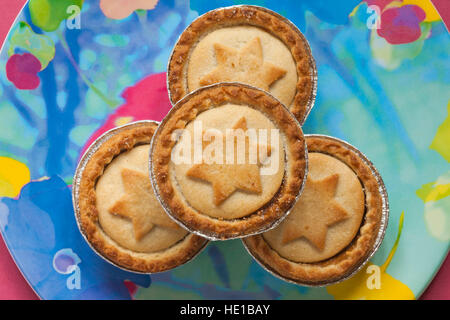 close up of mince pies with stars on, on colourful plate ready for Christmas Stock Photo