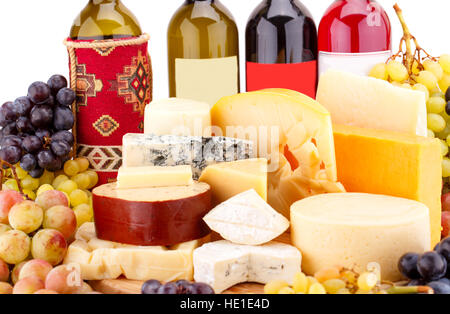 Various type of cheese,wines and grapes on wooden board closeup picture. Stock Photo