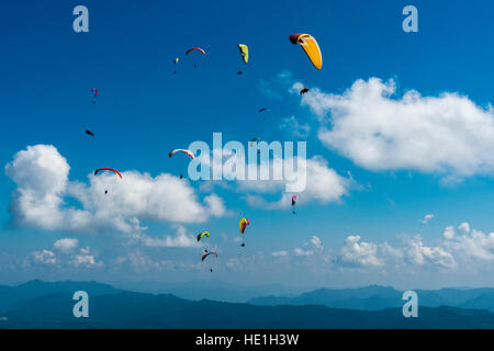 Many paragliders are flying over Pokhara and Phewa Lake Stock Photo