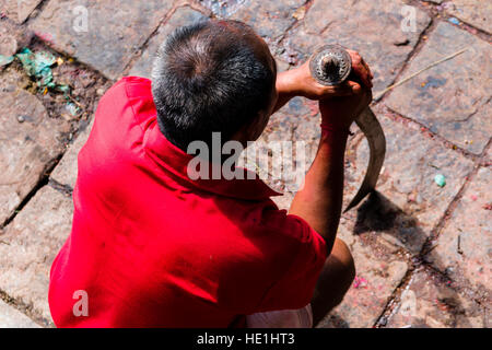 A priest is waiting with a big sword to sacrifice a water buffalo to the gods at the Gorakhnath temple at the hinduist festival Darsain Stock Photo