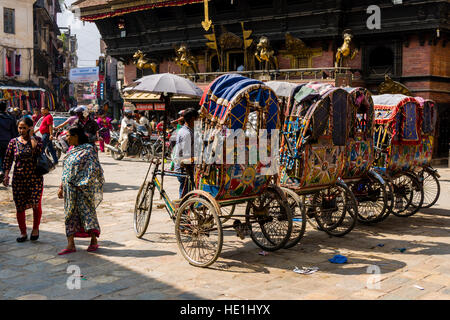 Bicycle rikshaws are standing on Indra Chowk in front of Akash Bhairab temple Stock Photo