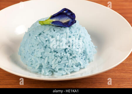 Blue Rice made cooking from Butterfly Pea flower (Clitoria ternatea L) in white dish. Rice has a colorful and fragrant flowers and good for health. Stock Photo