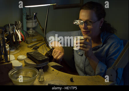 The goldsmith at her working space during a coffeebreak Stock Photo