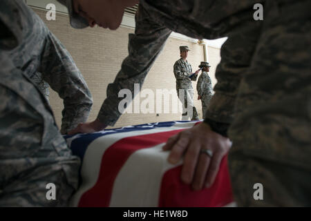 An Air Force military service detail assigned to Dover mortuary affairs, practice a dignified transfer at Dover Air Force Base, Delaware. The Air Force mortuary affairs unit at Dover remains prepared to service multiple fallen service members at one time, but the numbers have decreased dramatically after the draw down of military troops in Operation Enduring Freedom. /Staff Sgt. Vernon Young Jr. Stock Photo