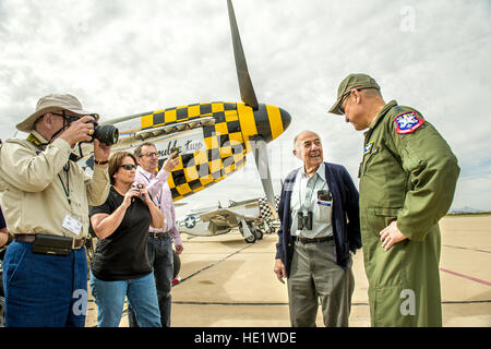 Fred Roberts, 93, second from right, a former P-51D pilot during WWII with the 354th Fighter Squadron, 355th Fighter Group in England, talks with Lt. Gen. Mark C. 'Chris' Nowland, Commander, 12th Air Force, Air Combat Command, and Commander, Air Forces Southern, U.S. Southern Command, Davis-Monthan Air Force Base, Ariz. during the Heritage Flight Training Course at Davis-Monthan AFB, Tucson, Ariz., Mar 6, 2016. Roberts was tasked with destroying 57 P-51s after the cease of hostilities in Europe; including one of the planes he flew in combat.  J.M. Eddins Jr. Stock Photo