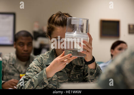 Airman Caroline Rogers looks at the larva of an Aedes mosquito during a public health training class at the School of Aerospace Medicine, Wright-Patterson Air Force Base, Ohio, April 19, 2016.  The Aedes mosquito can spread serious diseases such as dengue fever, yellow fever, the Zika virus and chikungunya. Aedes mosquitoes are visually distinctive because of the black and white markings on their body and legs. /Master Sgt. Brian Ferguson Stock Photo