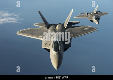 Two F-22 Raptors from the 95th Fighter Squadron at Tyndall Air Force Base, Fla., fly over the Baltic Sea on Sept. 4, 2015. Like the F-22 deployment last year, two F-22s deployed to Mihail Kogalniceanu Air Base, Romania. While in Europe, U.S. Air Force aircraft and Airmen will conduct air training with other Europe-based aircraft. /Tech. Sgt. Jason Robertson Stock Photo