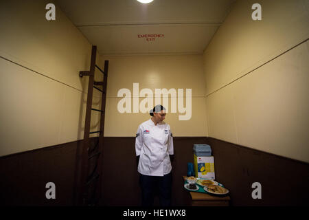 Airman 1st Class Alexandra Ayub descends in an elevator  to deliver meals to a launch control center approximately 60 feet below the surface of the missile alert facility where she is deployed. The missile chef provides meals for all the Airmen stationed at the MAF during a four-day rotation. /Staff Sgt. Andrew Lee Stock Photo