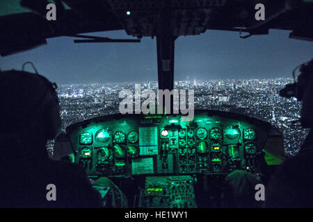 Capt. Jonathan Bonilla and 1st Lt. Vicente Vasquez, 459th Airlift Squadron UH-1N Huey pilots, fly over Tokyo after completing night training April 25, 2016. The 459th AS frequently trains on a multitude of scenarios in preparation for potential real-world contingencies and operations. /Yasuo Osakabe Stock Photo