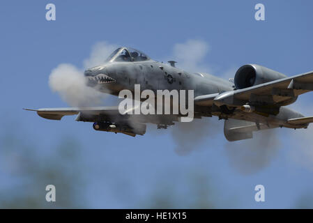 An A-10C Thunderbolt II assigned to the 75th Fighter Squadron performs a low-angle strafe during the Hawgsmoke competition at Barry M. Goldwater Range, Ariz., June 2, 2016. The two-day competition included team and individual scoring of strafing, high-altitude dive-bombing, Maverick missile precision and team tactics. /Senior Airman Chris Drzazgowski Stock Photo