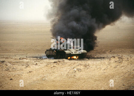 An Iraqi T-55 main battle tank burns after an attack by the 1st United Kingdom Armored Division during Operation Desert Storm. Stock Photo