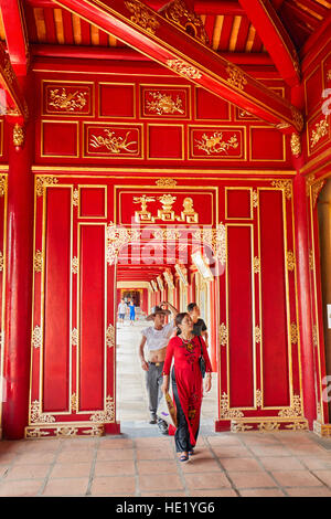 Vietnamese tourists walk in an open gallery in Khon Thai Residence (Queen's Private Apartment). Imperial City, Hue, Vietnam. Stock Photo