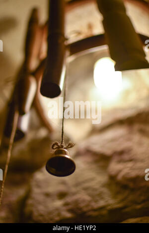 Bell on a string on a bamboo hand-made lamp, shot from below Stock Photo