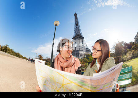 Two friends looking to map near Eiffel Tower Stock Photo