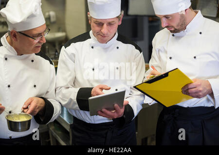 Consultation of chefs in the kitchen Stock Photo