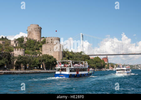 Cruise ships at Bosporus strait with Fatih Sultan Mehmet Bridge and Fortress Rumeli Hisari, Istanbul, Turkey, middle East Stock Photo