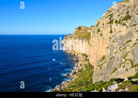 High coastal cliffs and deep blue sea in an evening sun Stock Photo