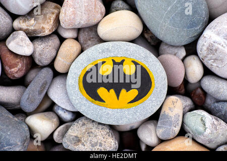 Paphos, Cyprus - November 22, 2016 Sign Batman painted on a pebble with stones background. Stock Photo