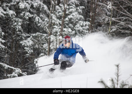 Skiing Teen in Blue Jacket Spraying Powder Stock Photo