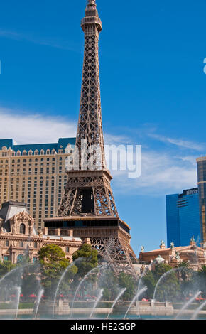 Paris, French-themed casino hotel with half-size Eiffel Tower in Las Vegas NV Bellagio fountains in foreground Stock Photo